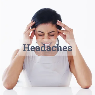 woman with tension headache, giving pain in side and front of head needing treatment